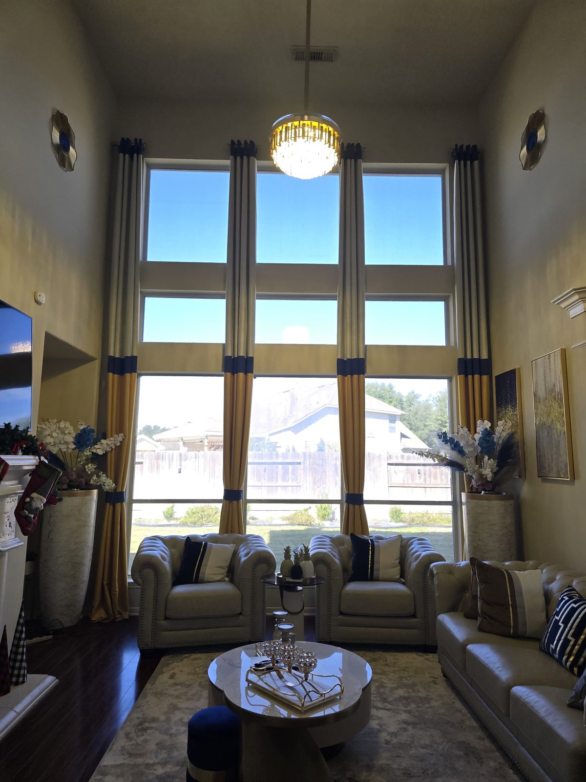 Finished living room with custom drapes and chandelier after handyman installation work