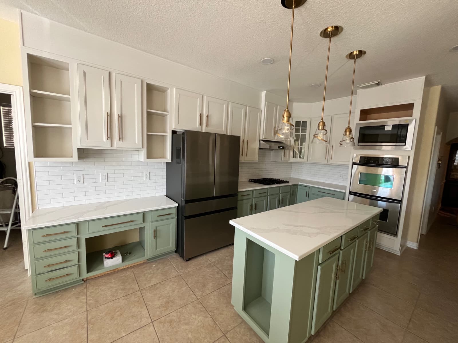 Sage kitchen island during remodel before final cabinet fronts.