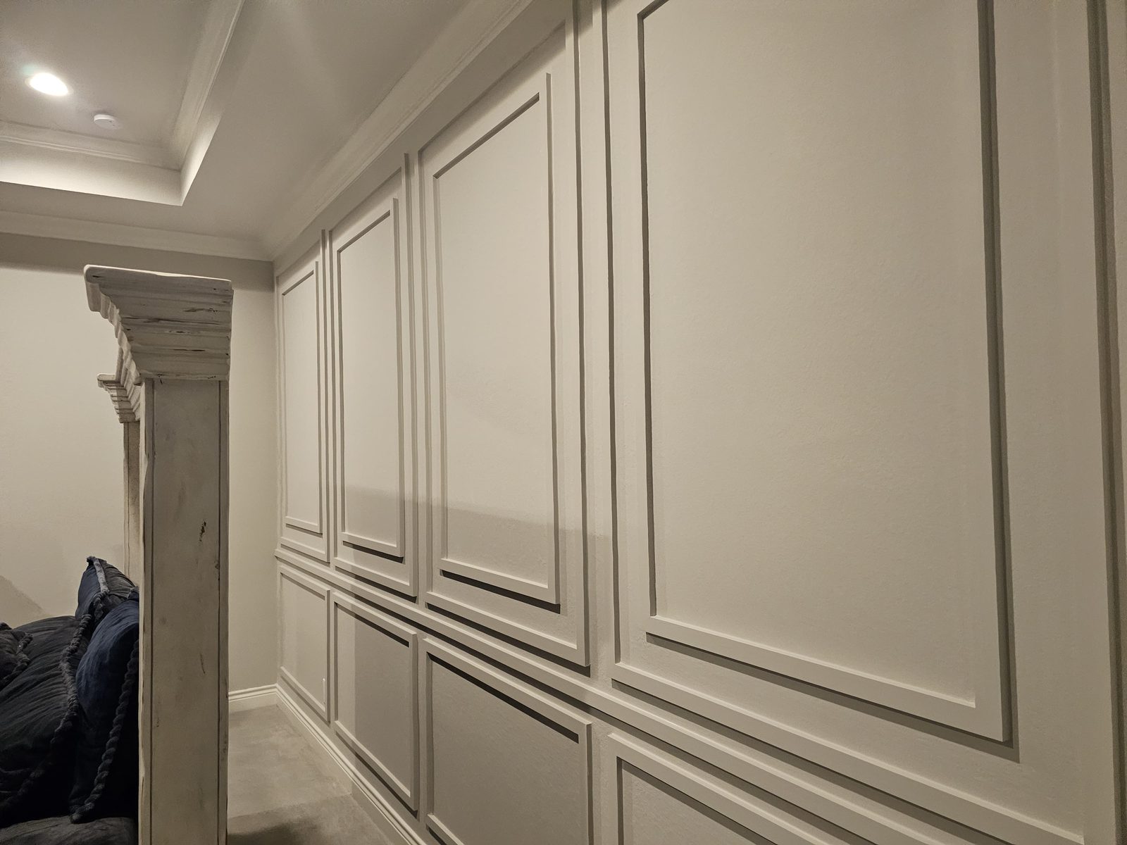 Bedroom accent wall with painted picture-frame molding and clean trim finish